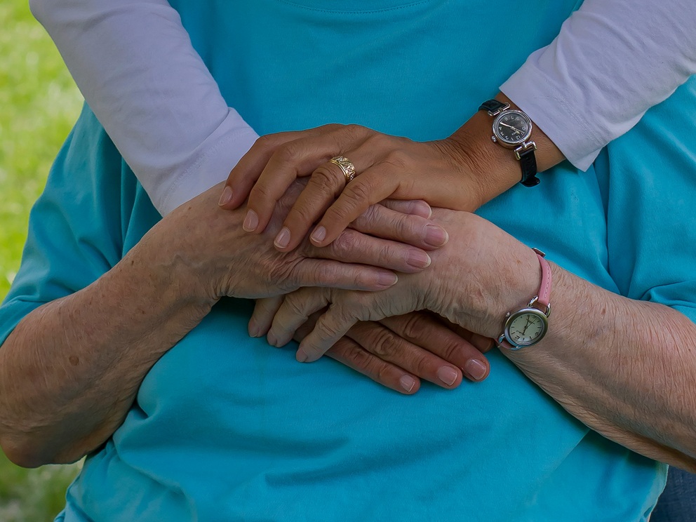 Elder couple holding hands