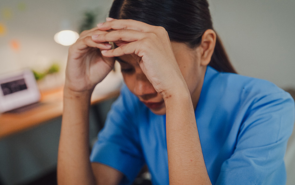 Woman sitting down with an upset expression